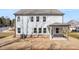 Two-story home featuring a covered patio and a backyard with grass at 219 Whispering Pines Ave, Conyers, GA 30094