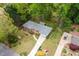 Aerial view of a well maintained home with a long driveway, mature trees and a large backyard at 2558 Landeau Cir, Tucker, GA 30084