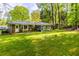 View of the expansive yard highlighting the lush greenery and wooded backdrop at 2558 Landeau Cir, Tucker, GA 30084