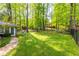 A fully fenced, lush green backyard provides privacy and space for outdoor activities at 2558 Landeau Cir, Tucker, GA 30084