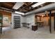 Unfinished basement with concrete floor, shelving, access to the outside and utility hookups at 2558 Landeau Cir, Tucker, GA 30084