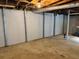 Unfinished basement with painted cinderblock walls, concrete floor and exposed utilities at 2558 Landeau Cir, Tucker, GA 30084