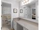 Bathroom with large vanity, neutral countertops, and a view into an adjacent room at 2558 Landeau Cir, Tucker, GA 30084