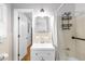 Bathroom with white tiled walls, modern fixtures, and convenient storage at 2558 Landeau Cir, Tucker, GA 30084