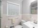 Well-lit bathroom with tiled walls, a modern sink, and white fixtures at 2558 Landeau Cir, Tucker, GA 30084