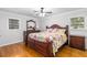 Bedroom with hardwood floors, a decorative bedspread, and ample natural light at 2558 Landeau Cir, Tucker, GA 30084