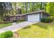 Charming brick home with a lush lawn, driveway, attached garage, and well-maintained landscaping at 2558 Landeau Cir, Tucker, GA 30084