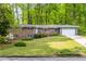 Charming single-story brick home with a well-manicured lawn and blue shutters at 2558 Landeau Cir, Tucker, GA 30084