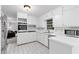 Bright kitchen featuring white cabinets, tile backsplash, and stainless steel appliances at 2558 Landeau Cir, Tucker, GA 30084