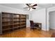 Home office featuring a built-in bookcase, desk area, and hardwood floors at 2558 Landeau Cir, Tucker, GA 30084