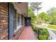 This single-Gathering home features brick, blue shutters and trim, and manicured landscaping at 2558 Landeau Cir, Tucker, GA 30084