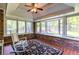 Sunroom featuring exposed brick, terra cotta tile and a wall of windows at 2558 Landeau Cir, Tucker, GA 30084