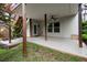 Concrete back porch showcasing ceiling fan, wooden posts, and view to the yard at 7340 Jamestown Dr, Alpharetta, GA 30005