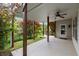 Cozy covered back porch with ceiling fan and lush green surroundings at 7340 Jamestown Dr, Alpharetta, GA 30005