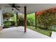 Covered porch with ceiling fan, wooden posts, and a serene view to the backyard at 7340 Jamestown Dr, Alpharetta, GA 30005