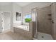 Bathroom showcasing a shower with glass doors and a separate soaking tub at 7340 Jamestown Dr, Alpharetta, GA 30005
