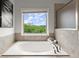 Bright bathroom features a soaking tub and a large window with a scenic view at 7340 Jamestown Dr, Alpharetta, GA 30005