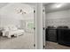 View into a bedroom and the laundry area with new black washer and dryer at 7340 Jamestown Dr, Alpharetta, GA 30005
