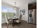 Bright dining area with stainless steel refrigerator and hardwood floors at 7340 Jamestown Dr, Alpharetta, GA 30005