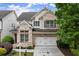 Charming two-story brick home featuring a two-car garage and beautifully landscaped front yard at 7340 Jamestown Dr, Alpharetta, GA 30005