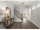 Open foyer with hardwood floors, a staircase, and a view of the front door at 7340 Jamestown Dr, Alpharetta, GA 30005