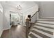 Open foyer with hardwood floors, a staircase, and a view of the living room at 7340 Jamestown Dr, Alpharetta, GA 30005