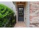 Inviting entryway with a brick path, a black front door, and lush greenery at 7340 Jamestown Dr, Alpharetta, GA 30005