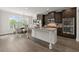 Modern kitchen with dark wood cabinetry, stainless steel appliances, and a granite island at 7340 Jamestown Dr, Alpharetta, GA 30005