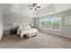 Spacious main bedroom with tray ceilings, carpet, a large window, and neutral colors at 7340 Jamestown Dr, Alpharetta, GA 30005