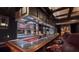 Basement bar with mirrored shelving, red cabinets, and leather barstools at 2230 Cammie Wages Rd, Dacula, GA 30019
