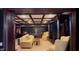 Finished basement with coffered ceilings, bar, sofa, fireplace, and ample seating at 2230 Cammie Wages Rd, Dacula, GA 30019