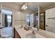 Double vanity in bathroom featuring walk-in shower with glass doors and wood-look flooring at 2230 Cammie Wages Rd, Dacula, GA 30019
