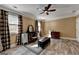 Large bedroom features wood-look floors, plaid curtains and furniture at 2230 Cammie Wages Rd, Dacula, GA 30019