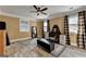Neutral Primary bedroom with luxury vinyl plank flooring, ceiling fan, and plaid curtains at 2230 Cammie Wages Rd, Dacula, GA 30019