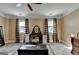 Large bedroom features wood-look floors, plaid curtains and furniture at 2230 Cammie Wages Rd, Dacula, GA 30019