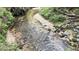 Beautiful, clear creek flowing through the property's wooded area at 2230 Cammie Wages Rd, Dacula, GA 30019