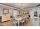 Formal dining room features hardwood floors, chandelier, traditional furnishings, and neutral wall color at 2230 Cammie Wages Rd, Dacula, GA 30019