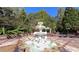 Elaborate water fountain surrounded by patio and mature trees at 2230 Cammie Wages Rd, Dacula, GA 30019