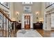 Elegant foyer featuring hardwood floors, staircase, and decorative lighting at 2230 Cammie Wages Rd, Dacula, GA 30019