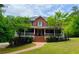 Charming two-story brick home with a welcoming front porch and lush landscaping at 2230 Cammie Wages Rd, Dacula, GA 30019