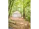 Detached garage with an overhead door surrounded by trees at 2230 Cammie Wages Rd, Dacula, GA 30019