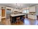 Spacious kitchen boasts an island, stainless steel appliances, granite countertops, and custom cabinetry at 2230 Cammie Wages Rd, Dacula, GA 30019