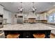 A large kitchen island takes center stage, complemented by stainless steel appliances and classic white cabinetry at 2230 Cammie Wages Rd, Dacula, GA 30019