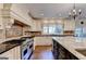 This kitchen features stainless steel appliances, a range hood, tile backsplash, and granite countertops at 2230 Cammie Wages Rd, Dacula, GA 30019