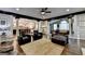 Open-concept living room featuring dark wood trim, hardwood floors, and decorative columns to adjacent kitchen at 2230 Cammie Wages Rd, Dacula, GA 30019