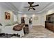 Spacious Primary bedroom featuring LVP flooring, plantation shutters, ceiling fan, and trey ceiling at 2230 Cammie Wages Rd, Dacula, GA 30019