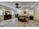 Spacious Primary bedroom featuring LVP flooring, plantation shutters, ceiling fan, and trey ceiling at 2230 Cammie Wages Rd, Dacula, GA 30019