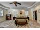 Spacious Primary bedroom featuring LVP flooring, plantation shutters, ceiling fan, and trey ceiling at 2230 Cammie Wages Rd, Dacula, GA 30019