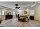 Spacious Primary bedroom featuring LVP flooring, plantation shutters, ceiling fan, and trey ceiling at 2230 Cammie Wages Rd, Dacula, GA 30019