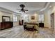 Spacious Primary bedroom featuring LVP flooring, plantation shutters, ceiling fan, and trey ceiling at 2230 Cammie Wages Rd, Dacula, GA 30019